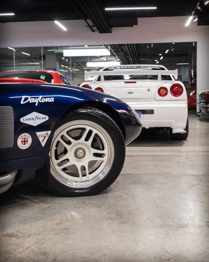 Showcase of vintage and modern cars in an automobile exhibition hall.